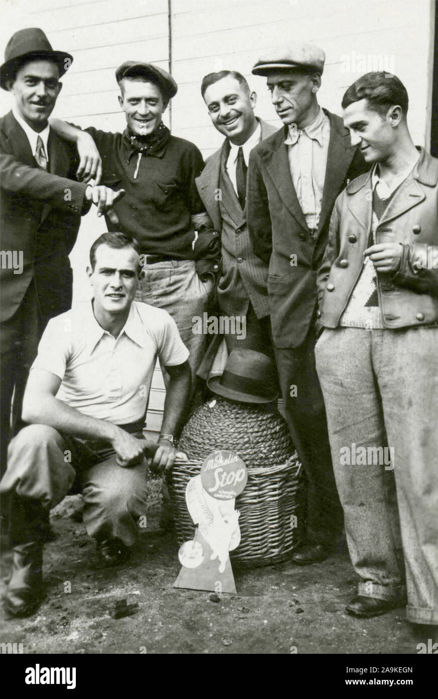 Group of men next to a demijohn of wine Stock Photo