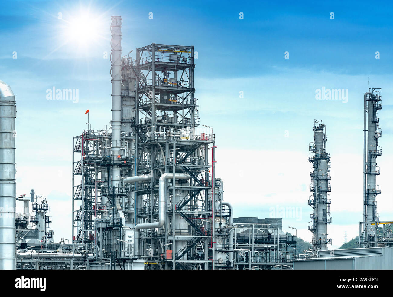Oil and gas refinery plant form industry petroleum zone,Refinery equipment pipeline steel and oil storage tank at sunrise. -image Stock Photo