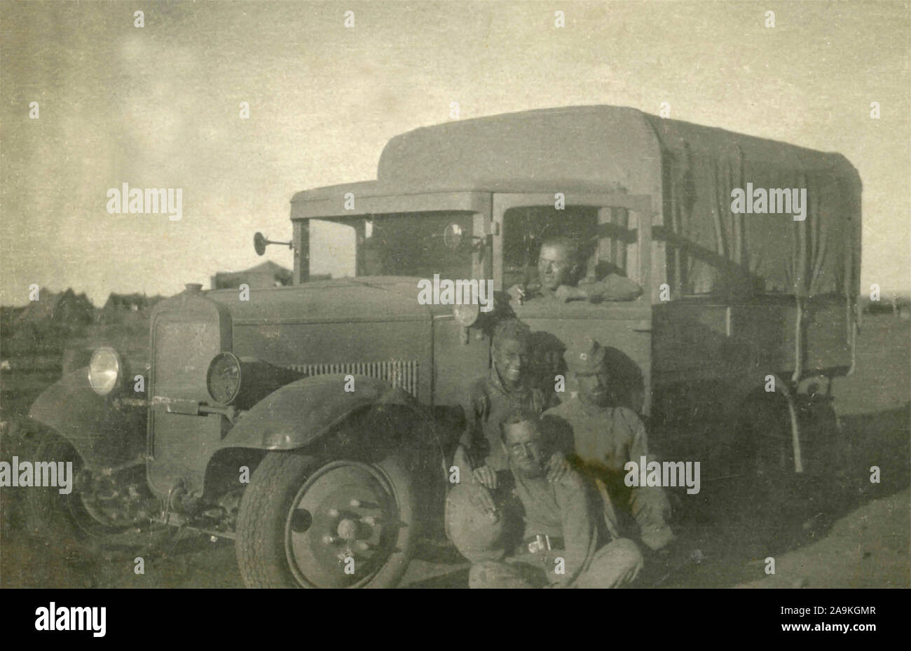 A group of soldiers around an Italian army trucks Stock Photo