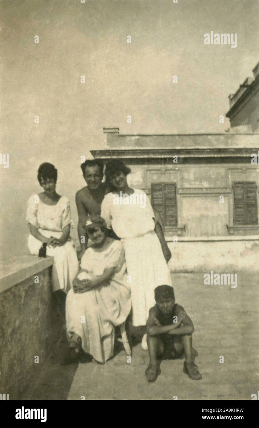 Small family group on the terrace, Italy Stock Photo