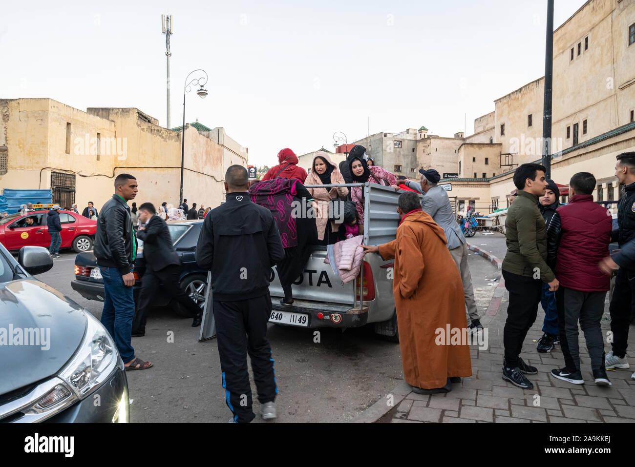 Fez, Morocco. November 9, 2019.   some people get on a small pickup truck Stock Photo