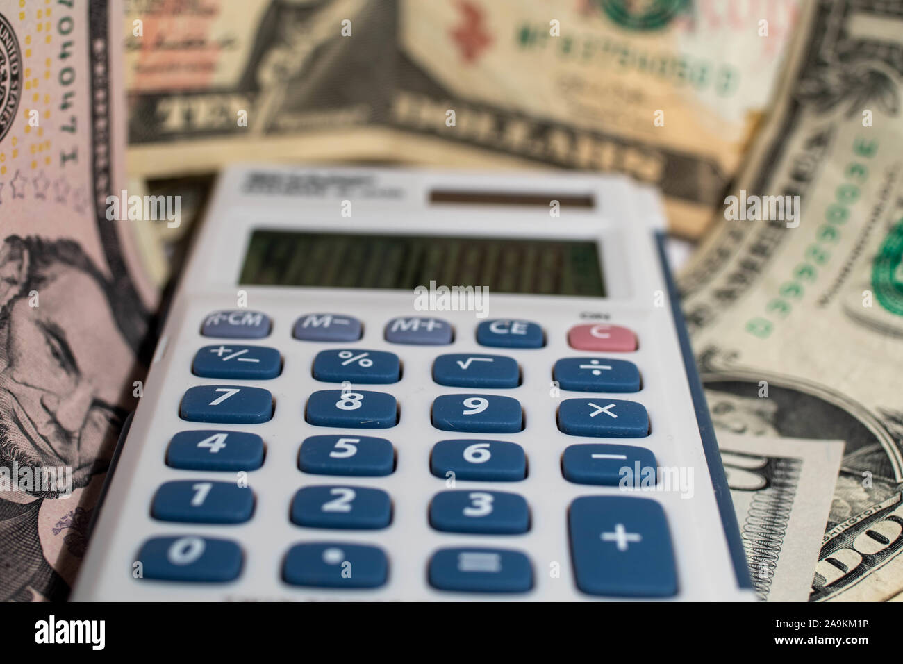 Calculator with money in the background Stock Photo