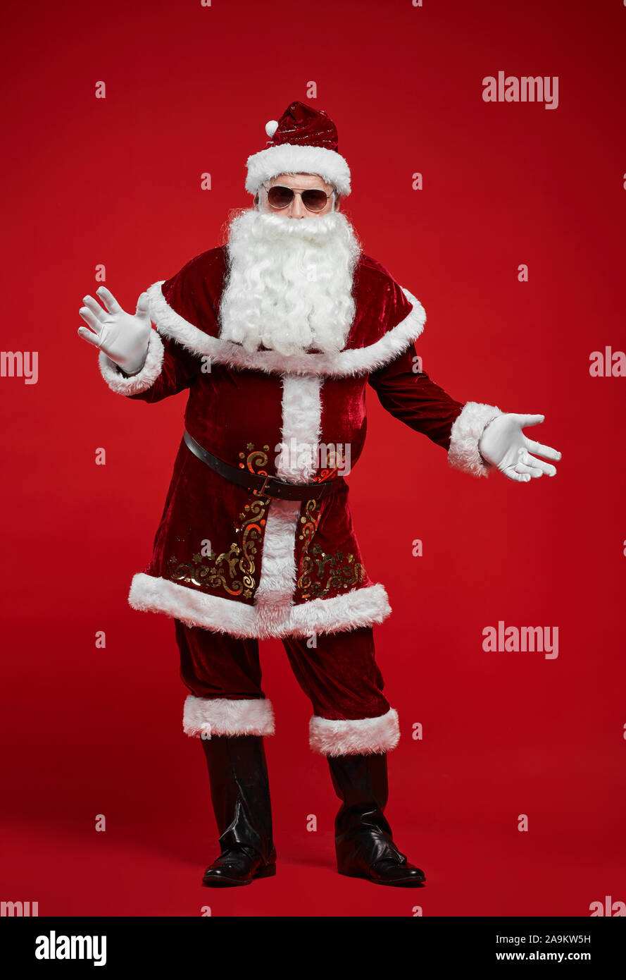 Portrait of Santa Claus in red beautiful costume wearing sunglasses and ...