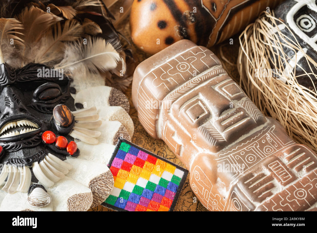 Indian sculptures from various parts of South America along with the flag of all Native Indians Stock Photo
