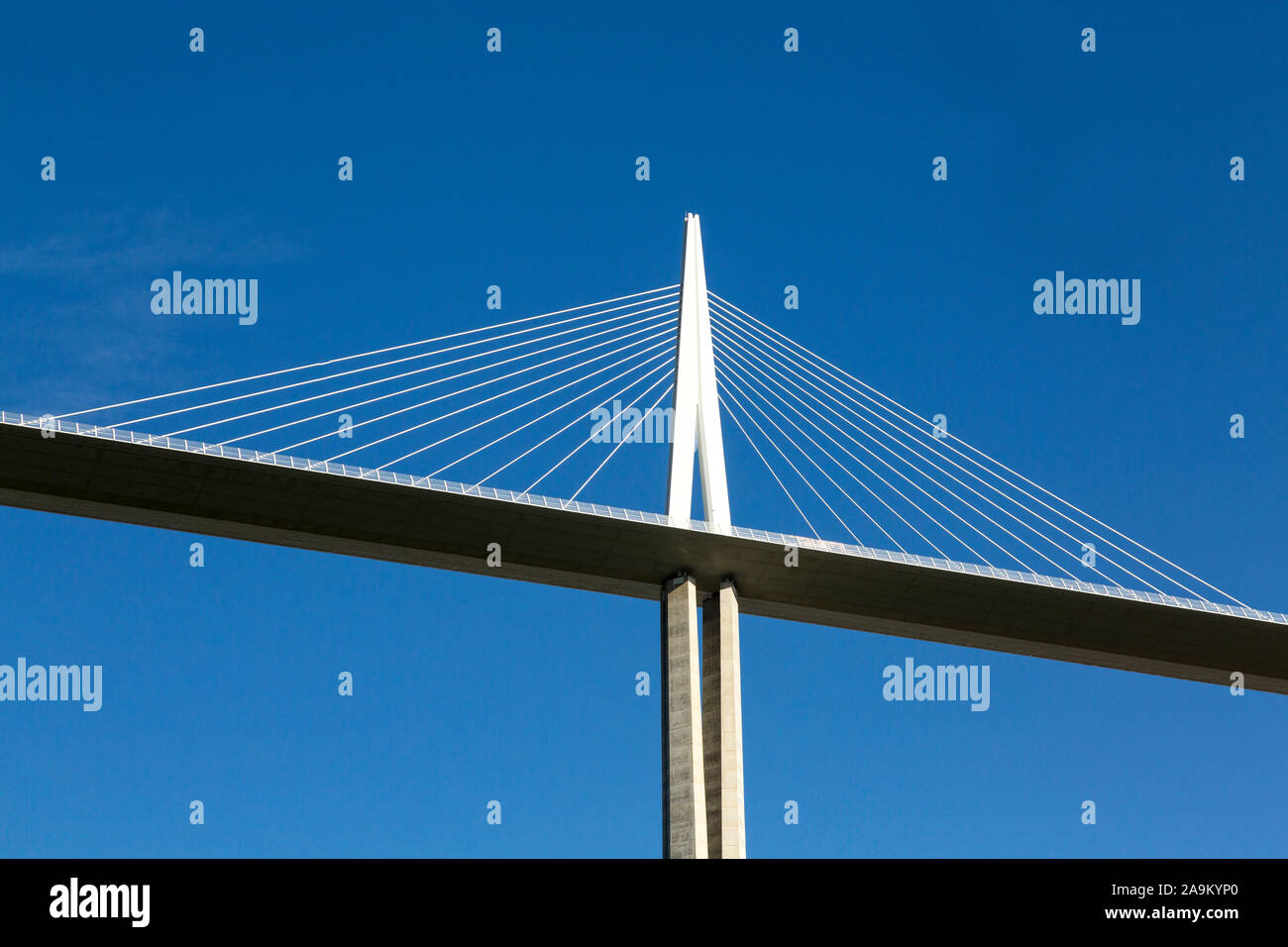 One pylon of the Millau viaduct against a blue sky, photographed from below Stock Photo