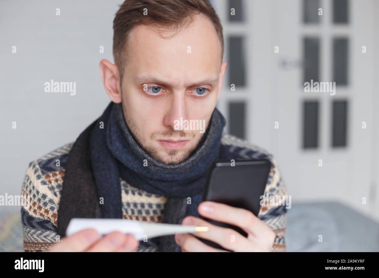 Man is self-medicating looking for treatment on the Internet instead of visiting a doctor. Stock Photo
