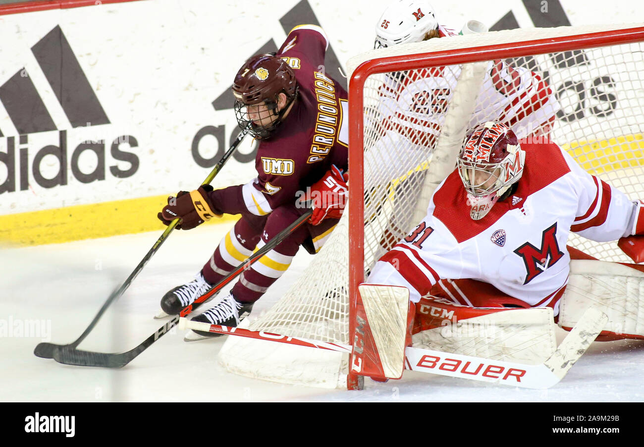 Oxford, Ohio, USA. 15th Nov, 2019. Minnesota Duluth's Scott Perunovich (7) tries a wrap around Miami's Ryan Larkin (31) during an NCAA hockey game between the Miami Redhawks and the Minnesota Duluth Bulldogs at the Goggin Ice Center in Oxford, Ohio. Kevin Schultz/CSM/Alamy Live News Stock Photo