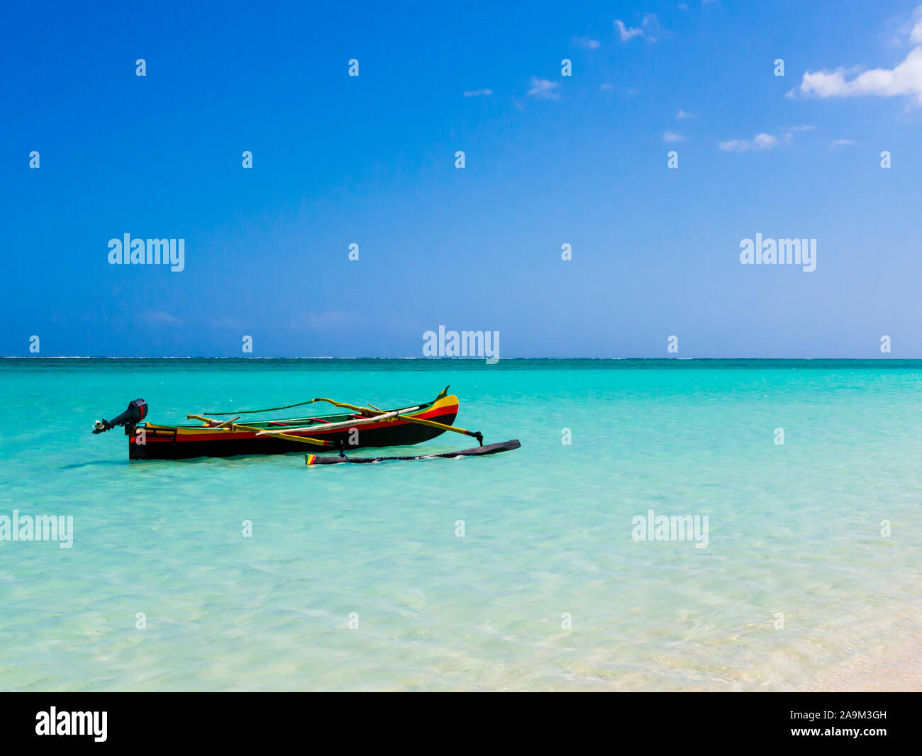 Colorful fishermen pirogue moored on turquoise sea of Nosy Ve island, Indian Ocean, Madagascar Stock Photo