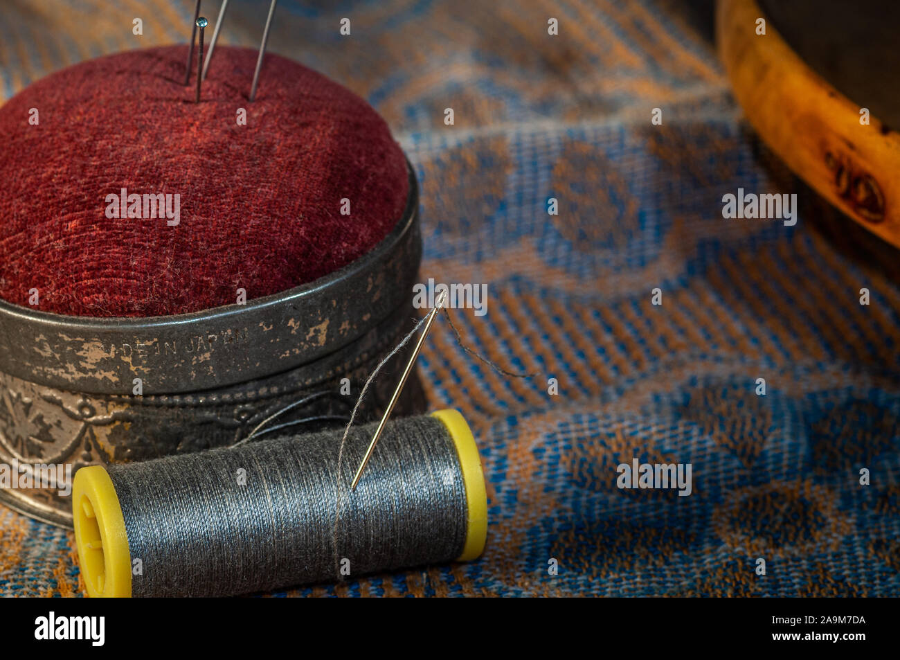 needle and thread sewing.grey thread ,with pin cushion Stock Photo Alamy