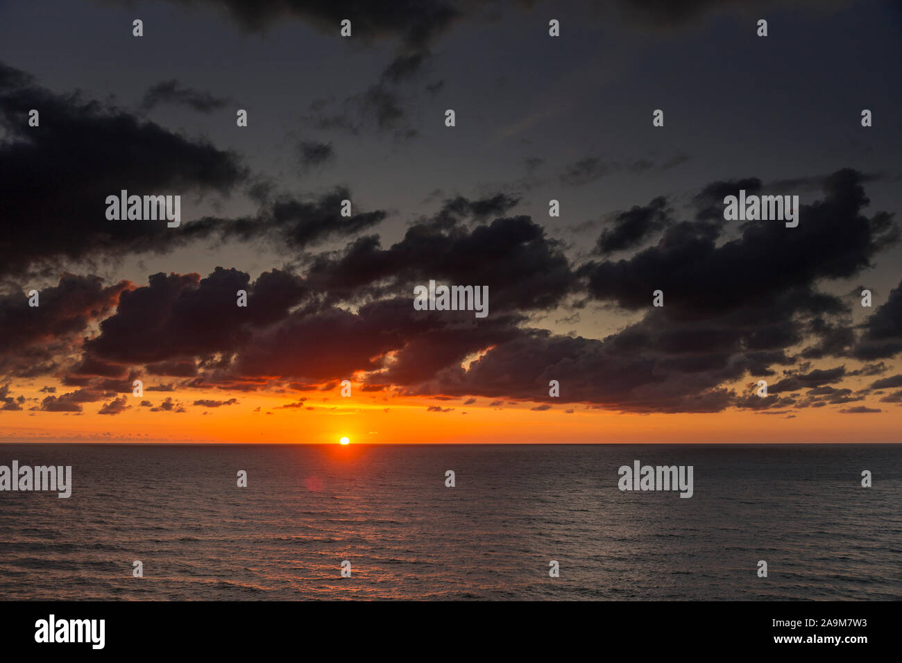 Sunset over the Atlantic ocean from Widemouth Bay on the north Cornwall coast Stock Photo