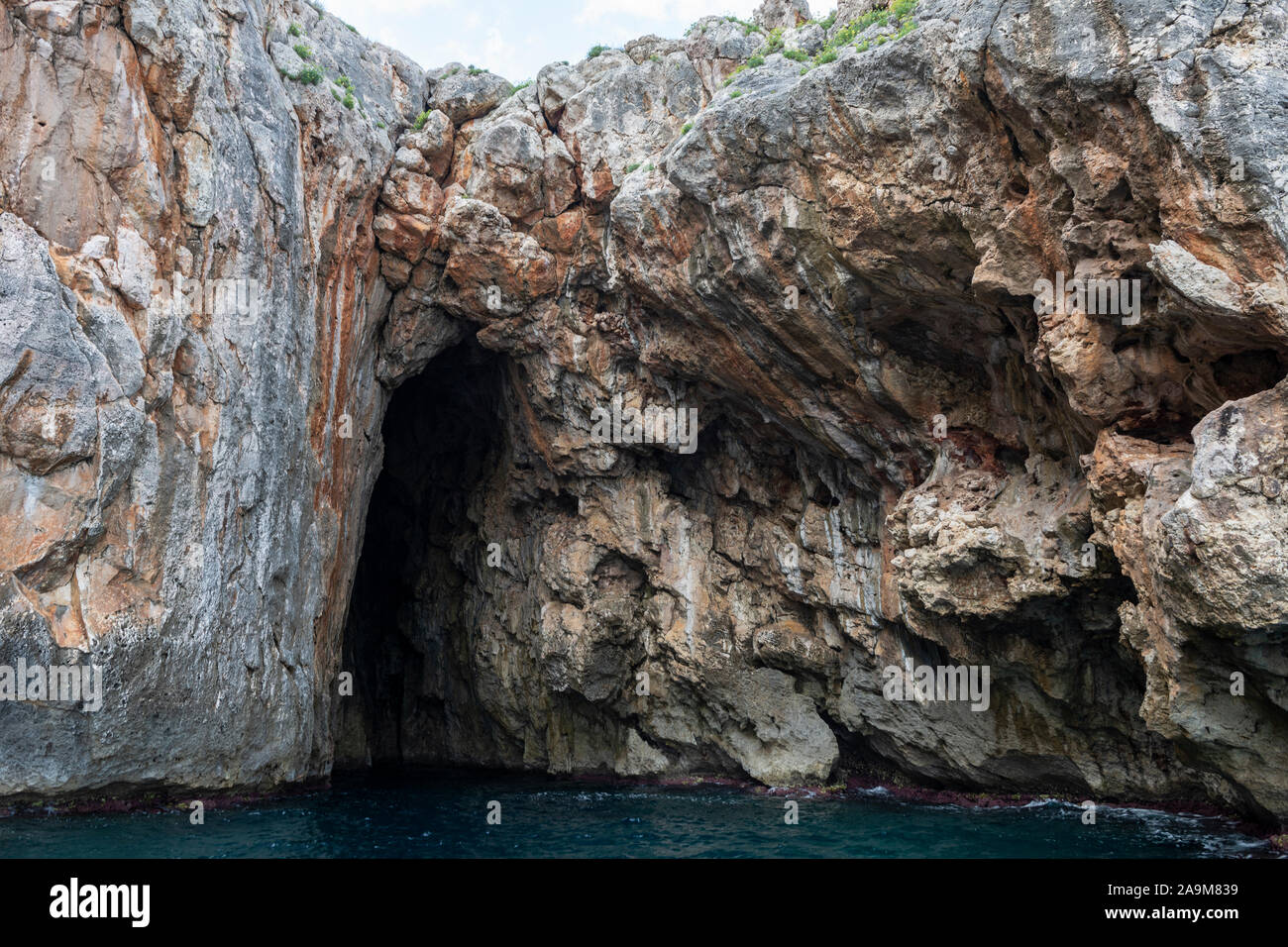 Sea cliffs and caves view from sea at Santa Maria di Leuca in Apulia (Puglia) in Southern Italy Stock Photo