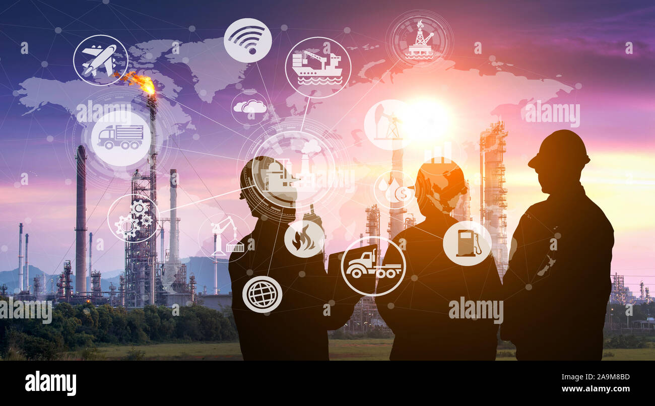 Double exposure silhouette of  engineering team working at oil refinery plant at twilight Stock Photo