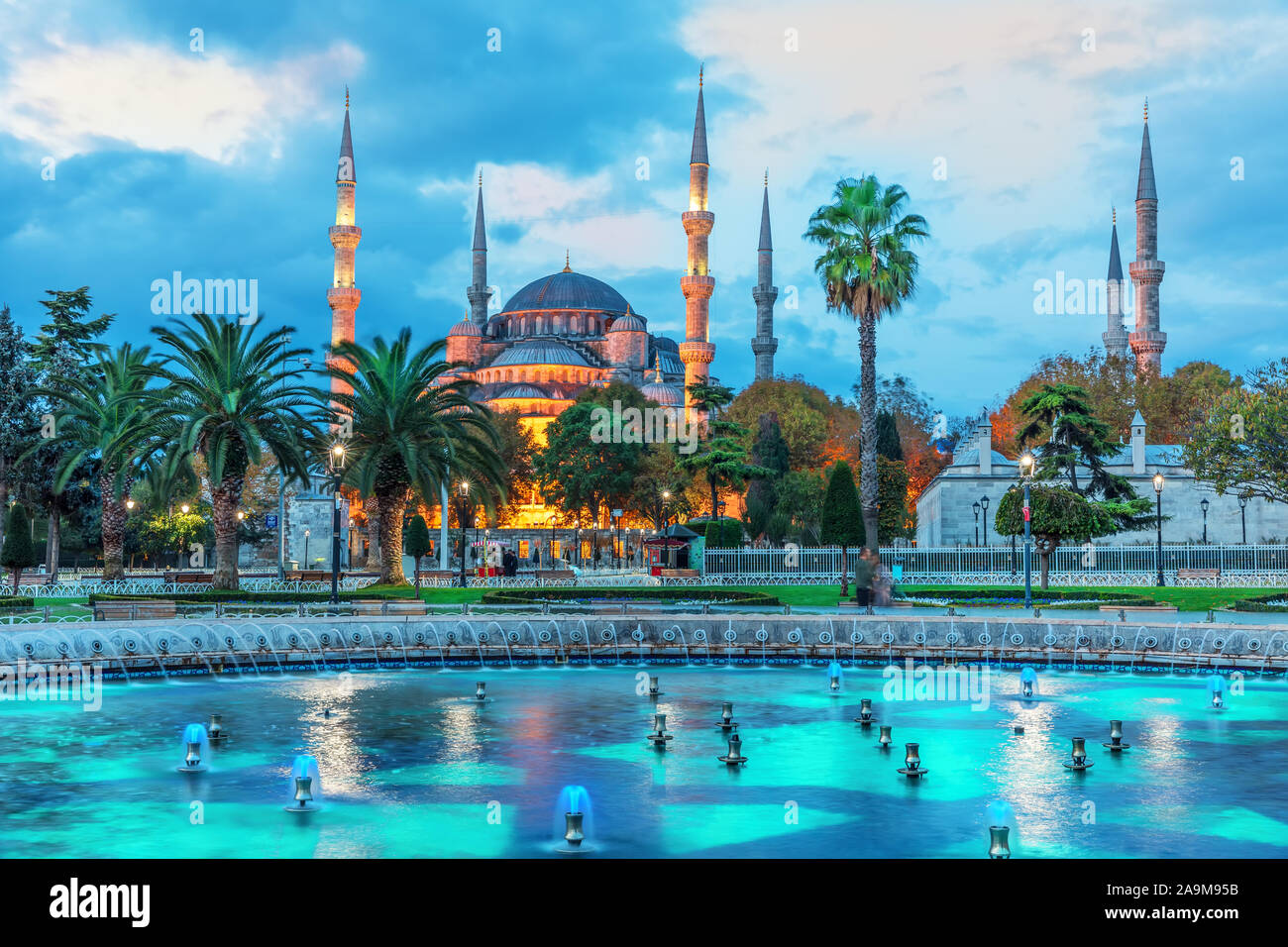 The Sultan Ahmet Mosque and the fountain in the blue shadows of sunrise ...