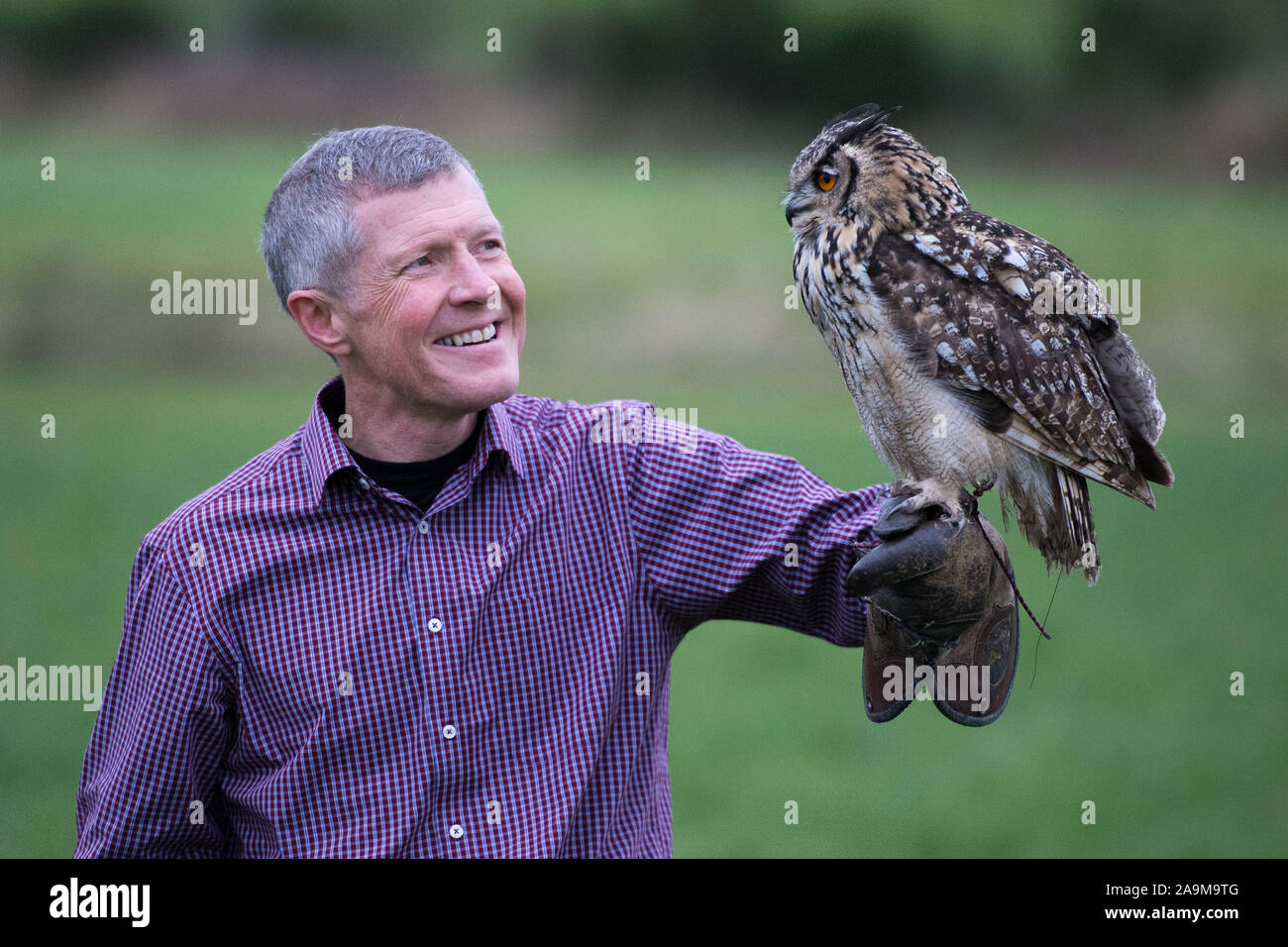 Glasgow, UK. 16 November 2019.   Pictured: Willie Rennie MSP - Leader of the Scottish Liberal Democrat Party, posing with Sage the Owl.  Scottish Liberal Democrat Leader Willie Rennie visits the Falconry centre in Cluny to highlight the threat Brexit poses on the environment and biodiversity loss. Credit: Colin Fisher/Alamy Live News Stock Photo