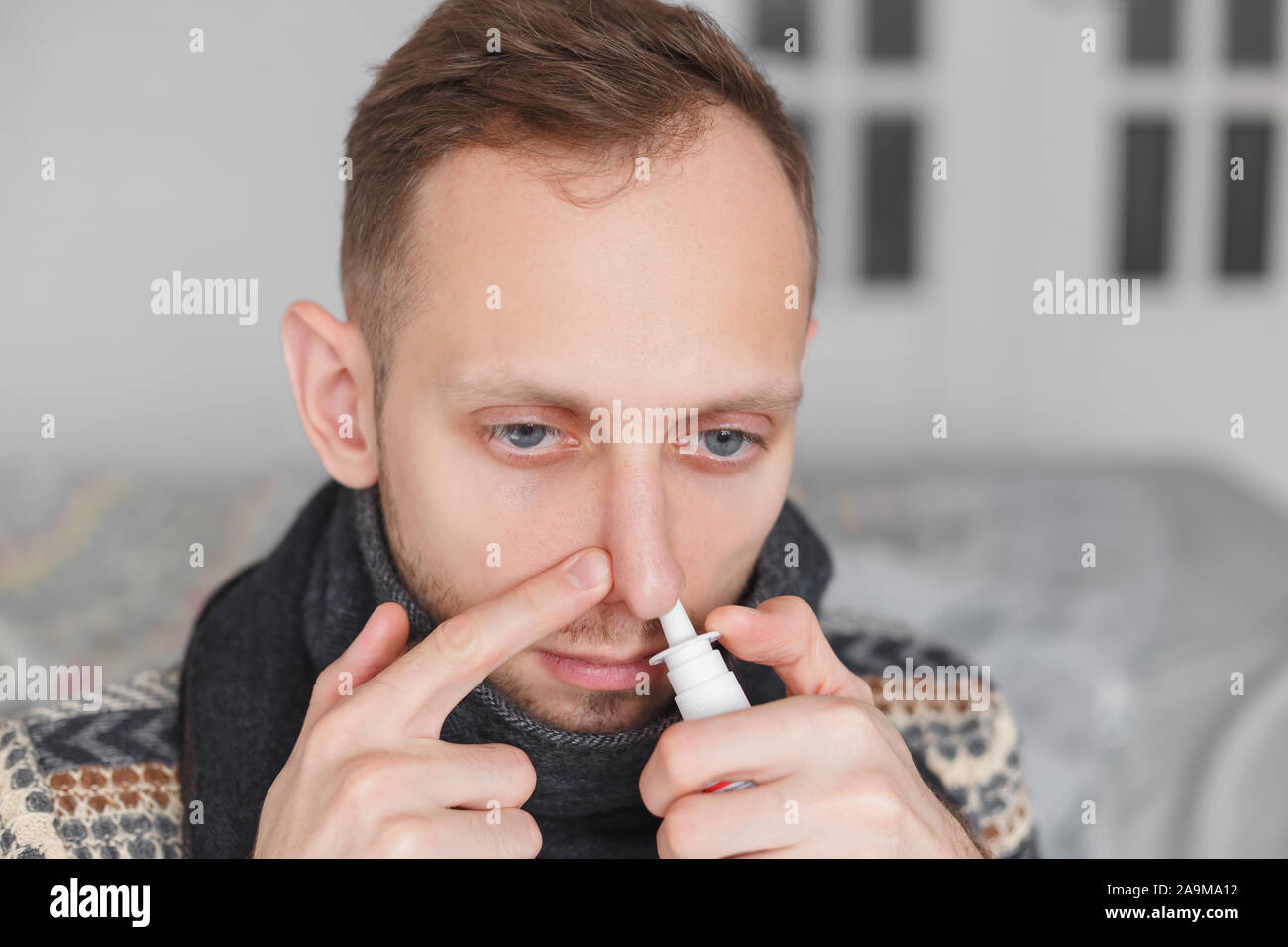 Man use nasal spray. concept of treatment for allergies or the common