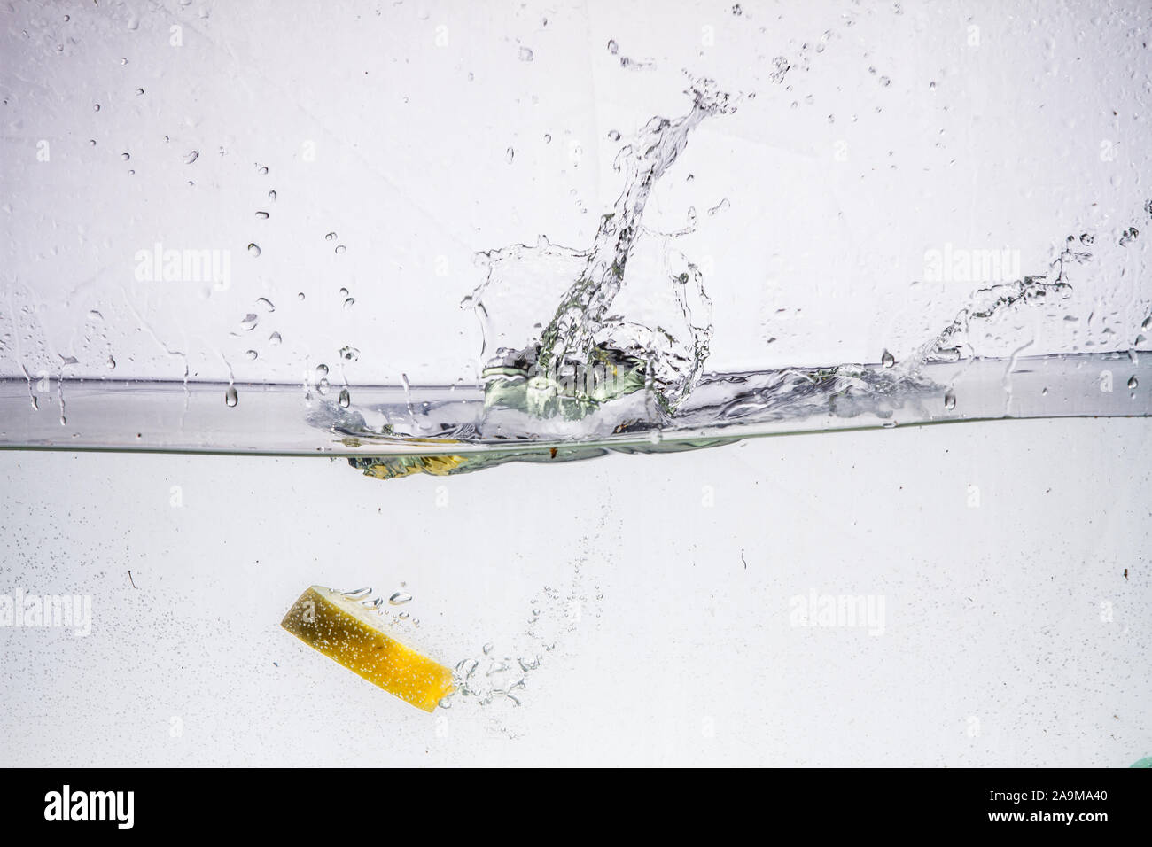 A background of bubbles forming in blue water after fruits is dropped ...