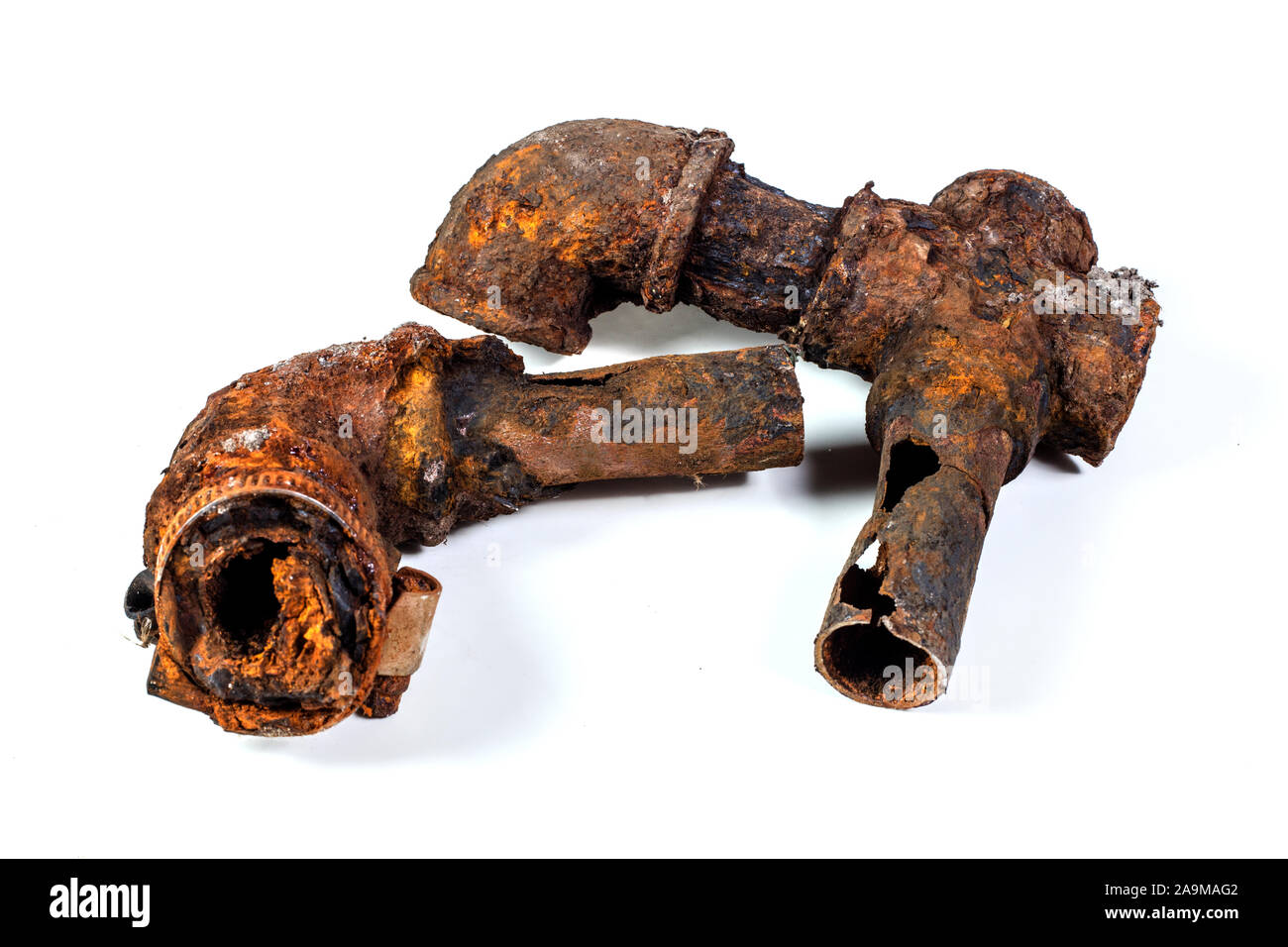 Fragments of old castiron water pipes on white background. After many