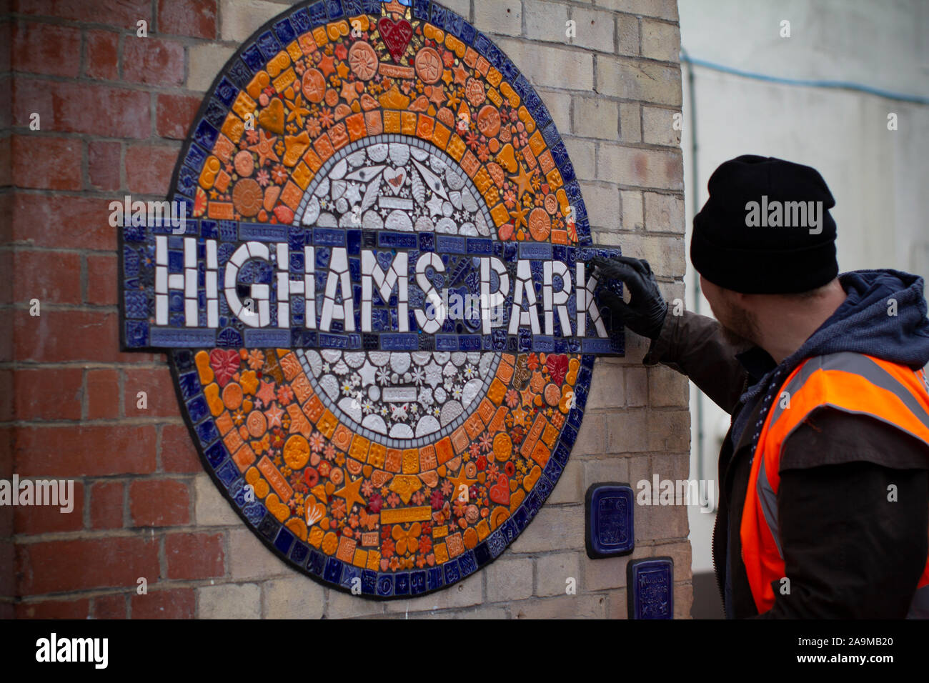 finishing touches being made to Mosaic Roundel on London Overground