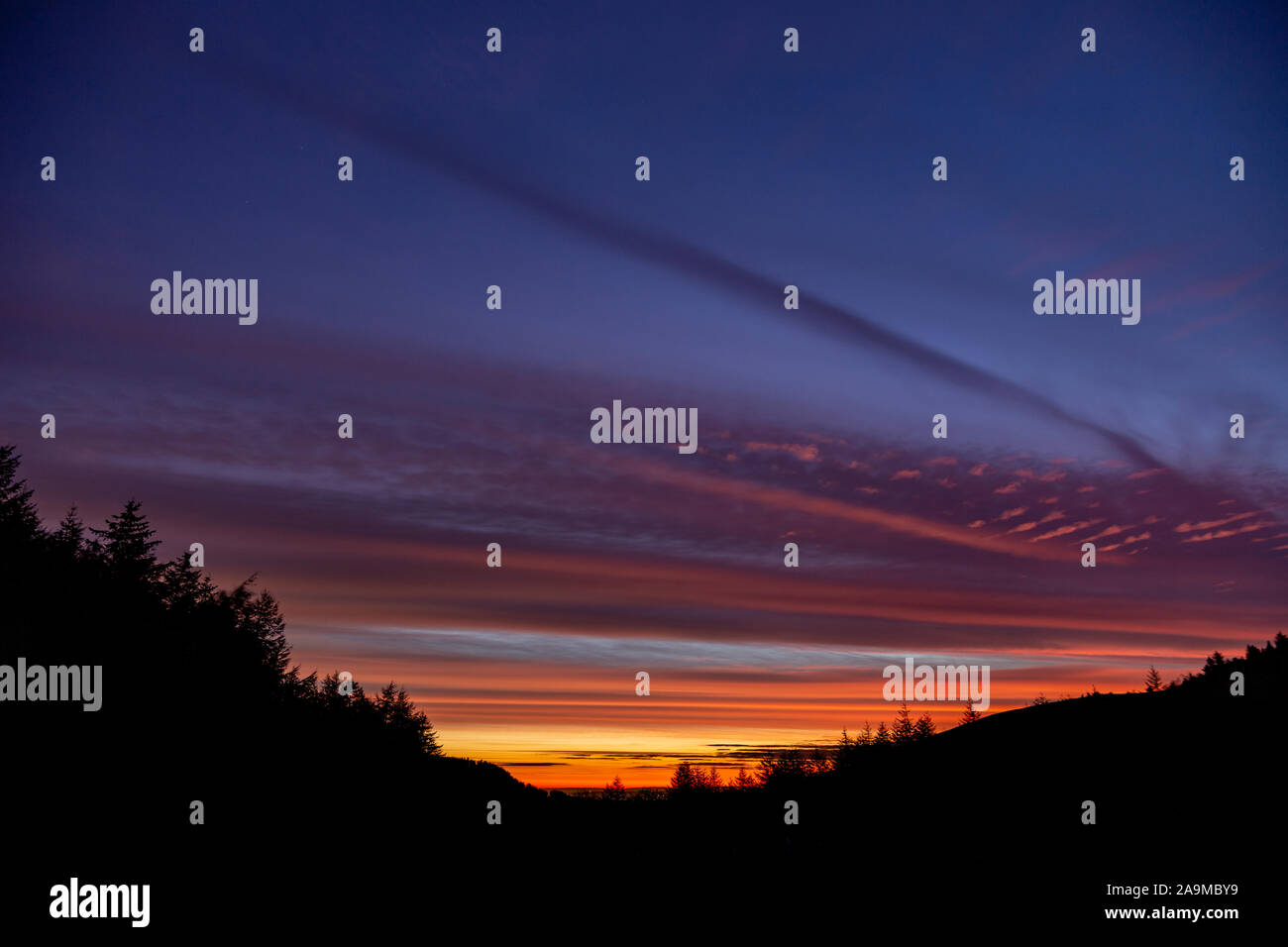 Colourful clouds at sunrise over the Clwydian Range AONB, North Wales Stock Photo