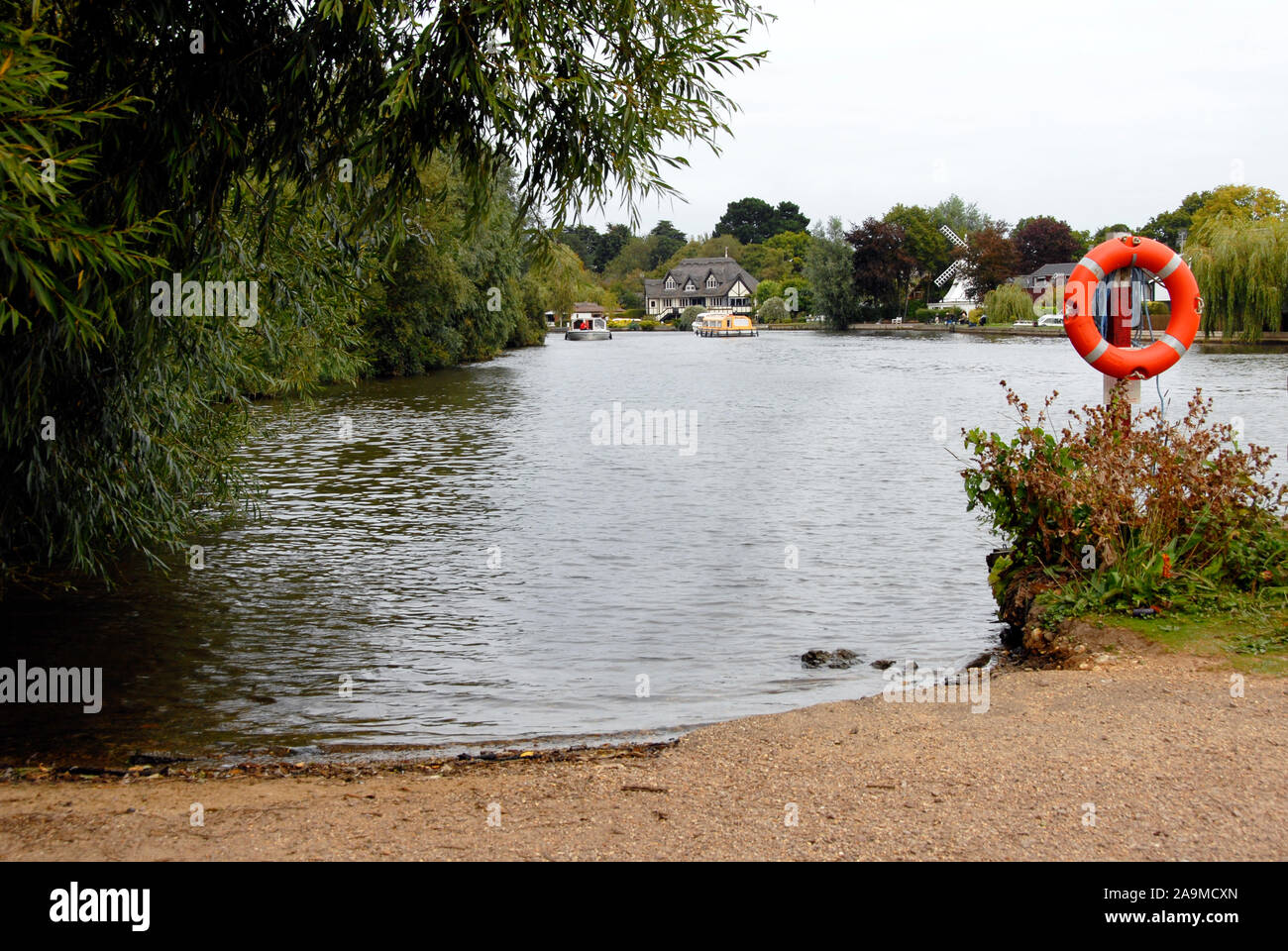 Quiet bay on the river Bure, Norfolk, England, with lifebelt Stock Photo