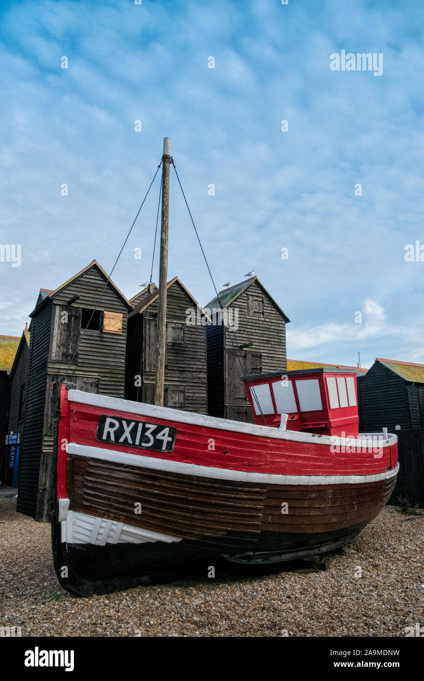 Fishing boat and traditional net huts, Hastings Old Town, The Stade, Rock a Nore, Hastings, East Sussex, UK Stock Photo