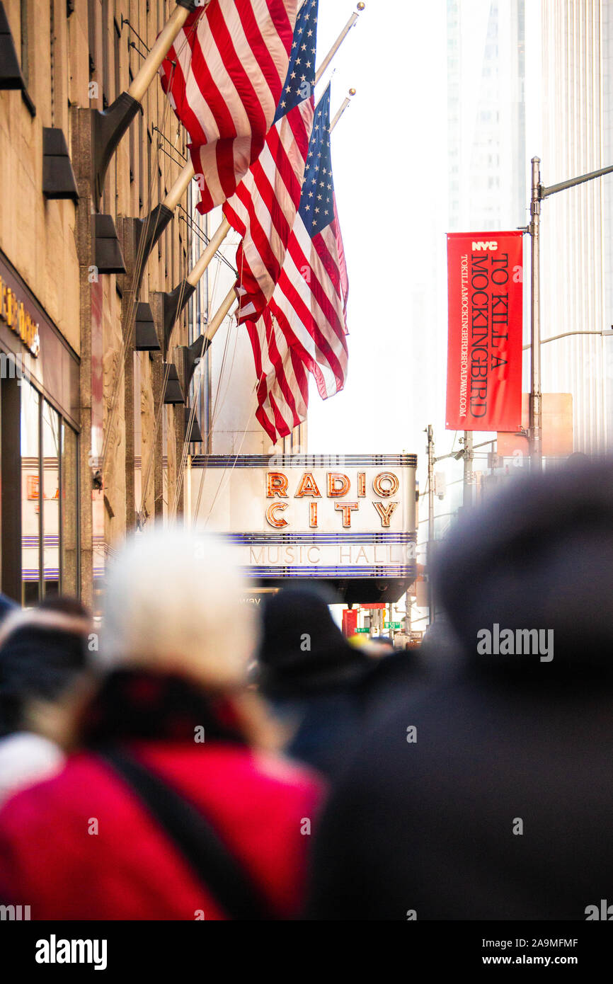 NEW YORK CITY - DECEMBER 7, 2018: Street scene at Christmas time with many people visible, seen in midtown Manhattan near Radio City Music Hall. Stock Photo