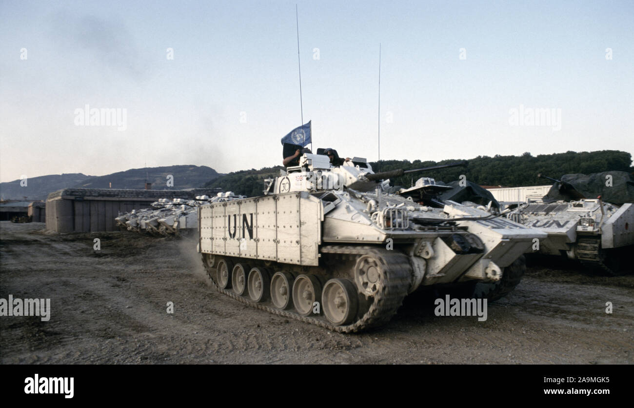 10th July 1993 During the war in Bosnia: just after sunrise, a Warrior MCV (Mechanised Combat Vehicle) of the Cheshire Regiment departs the 'Warrior park' of the British Army base near Vitez. Stock Photo