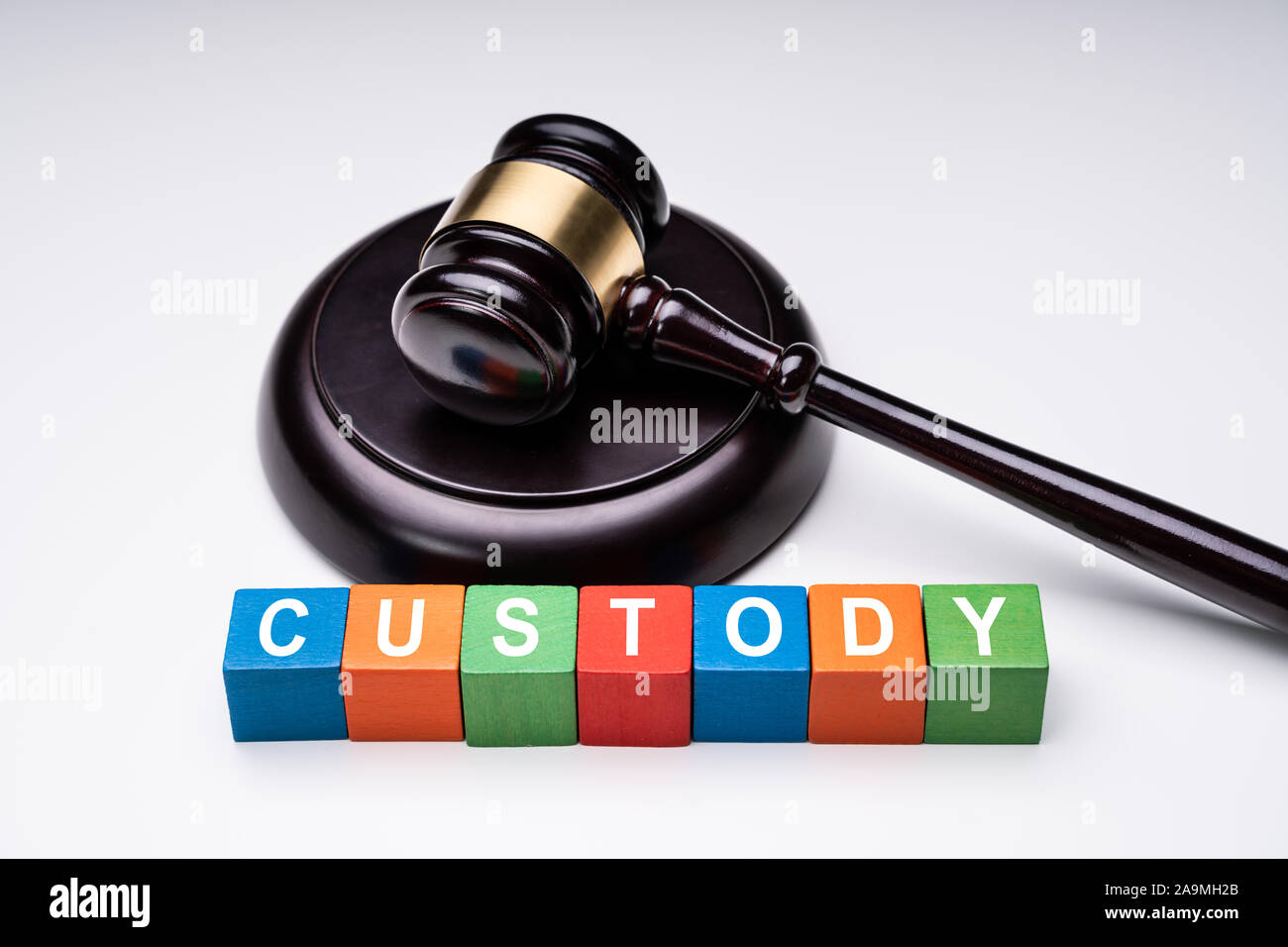 Colorful Cubes With Custody Text Near Striking Block With Gavel On White Background Stock Photo