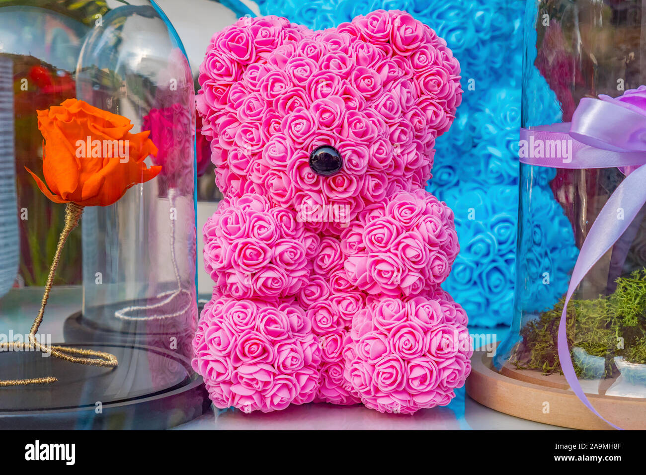 Pink teddy bear toy of foamirane roses. Red artificial rose in clear box  with black basis on background. Craftsmanship background. Handmade toys for  V Stock Photo - Alamy