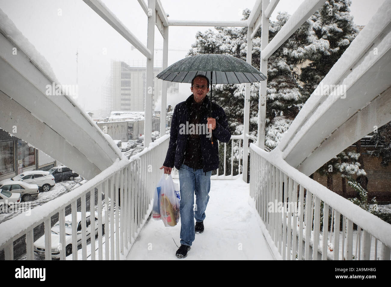 Tehran, Iran. 16th Nov, 2019. Iranians walk amid the snow in the capital Tehran. Heavy snowfall blanketed the streets of north Tehran on Saturday, causing traffic chaos and forcing the closure of schools, authorities in the Iranian capital said. Credit: Rouzbeh Fouladi/ZUMA Wire/Alamy Live News Stock Photo