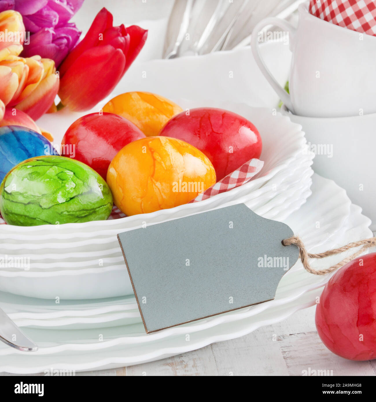 Easter Decoration Breakfast Table Red Tulips with red Easter Eggs as Background Stock Photo