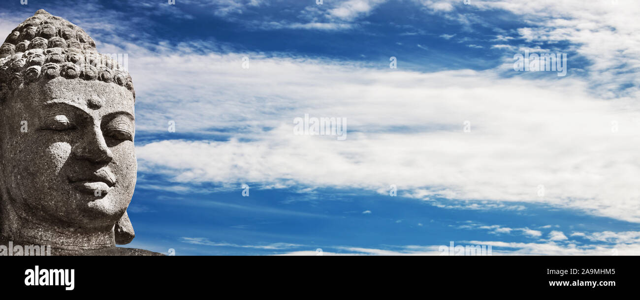 Buddah head on sky as background Stock Photo