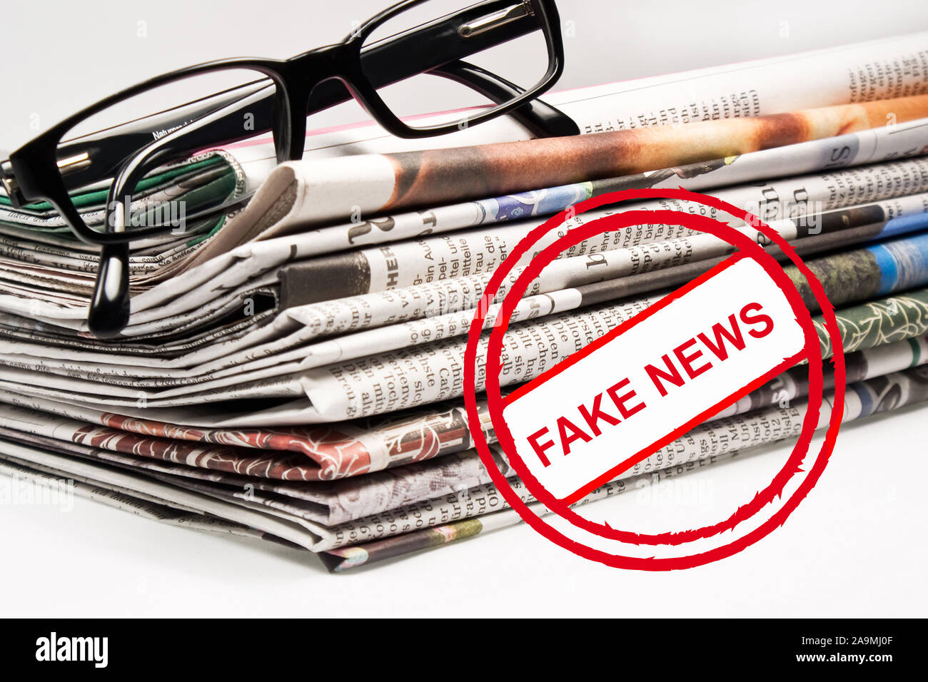 Daily newspaper and glasses fake news as background Stock Photo
