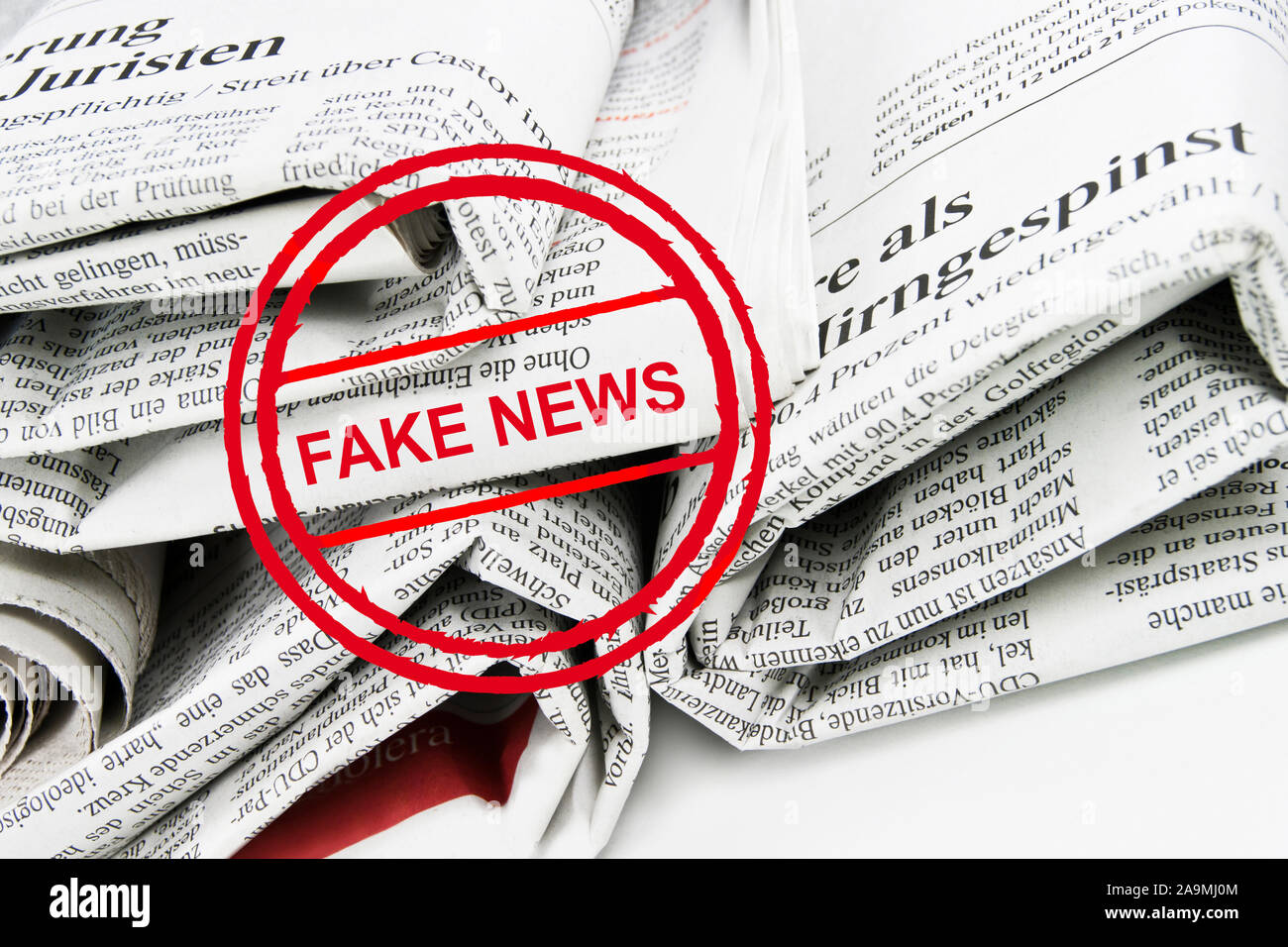 Stack with newspaper rolls and stamp fake news background Stock Photo