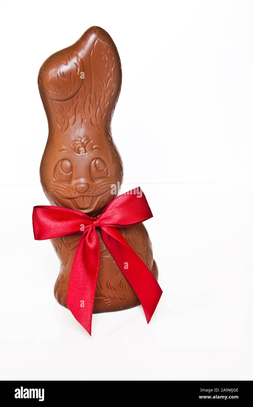 Chocolate Easter bunny with red ribbon on white background Stock Photo Alamy