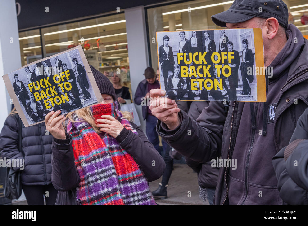 London, UK. 16th November 2019. Anarchists join the protest saying 'Why Vote? Revolt!' as FCKBoris in orange knitted hats walk through Uxbridge shopping centre handing out fliers urging everyone to register and vote against Boris Johnson and kick him out for his racist, elitist politics. They marched with a sound system on a bus to Brunel University to persuade students. Johnson had a majority of just over 5 thousand in 2017 and Labour candidate Ali Milani has strong hopes of beating him and the other 10 candidates. Peter Marshall/Alamy Live News Stock Photo