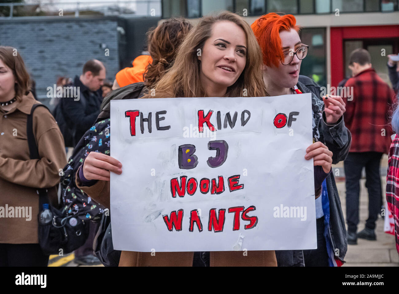 London, UK. 16th November 2019. A woman holds a poster 'The Kind of BJ Noone wants' as protesters from FCKBoris at Brunel University in Uxbridge  urging everyone to register and vote against Boris Johnson and kick him out for his racist, elitist politics.  Johnson had a majority of just over 5 thousand in 2017 and Labour candidate Ali Milani has strong hopes of beating him and the other 10 candidates. Peter Marshall/Alamy Live News Stock Photo