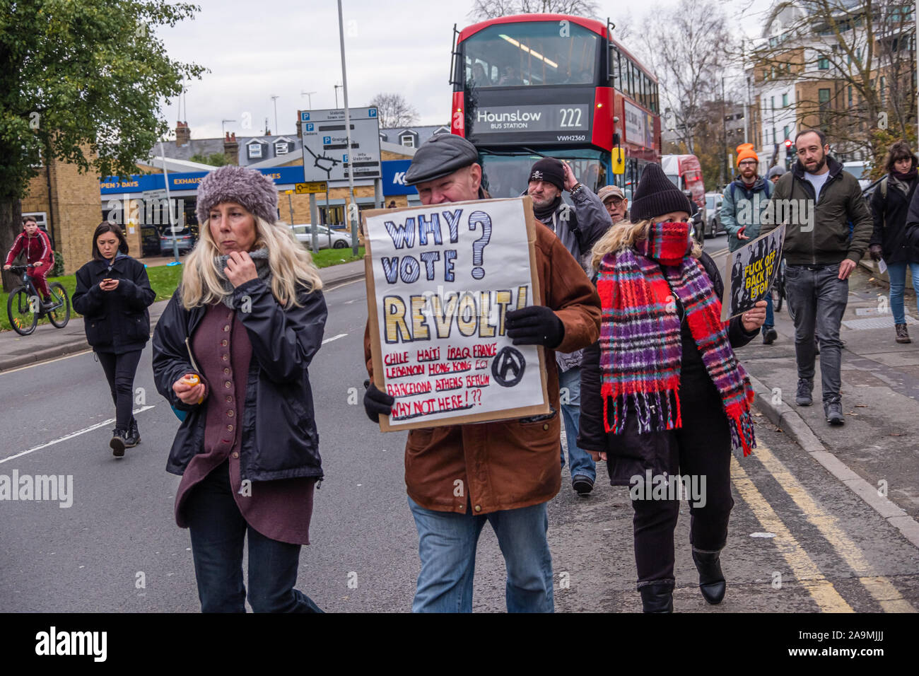 London, UK. 16th November 2019. Anarchists on the FCKBoris march through Uxbridge  urge people to revolt rather than vote. The march urged everyone to vote against Boris Johnson and kick him out for his racist, elitist politics. They marched with a sound system on a bus to Brunel University to persuade students. Johnson had a majority of just over 5 thousand in 2017 and Labour candidate Ali Milani has strong hopes of beating him and the other 10 candidates. Peter Marshall/Alamy Live News Stock Photo
