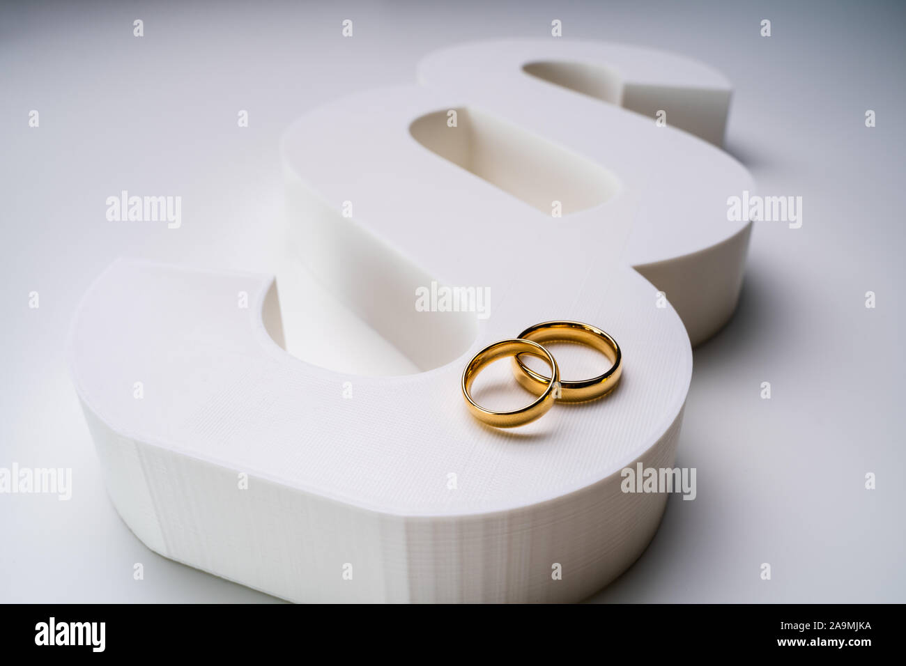 White Paragraph Sign And Golden Wedding Ring Showing Marriage And Law Concept Stock Photo