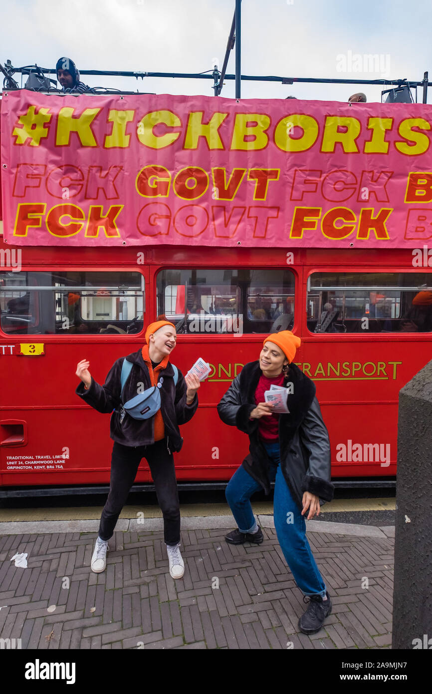 London, UK. 16th November 2019. People dance to music from the bus. Protesters from FCKBoris in orange knitted hats walk through Uxbridge shopping centre handing out fliers urging everyone to register and vote against Boris Johnson and kick him out for his racist, elitist politics. They marched with a sound system on a bus to Brunel University to persuade students. Johnson had a majority of just over 5 thousand in 2017 and Labour candidate Ali Milani has strong hopes of beating him and the other 10 candidates. Peter Marshall/Alamy Live News Stock Photo
