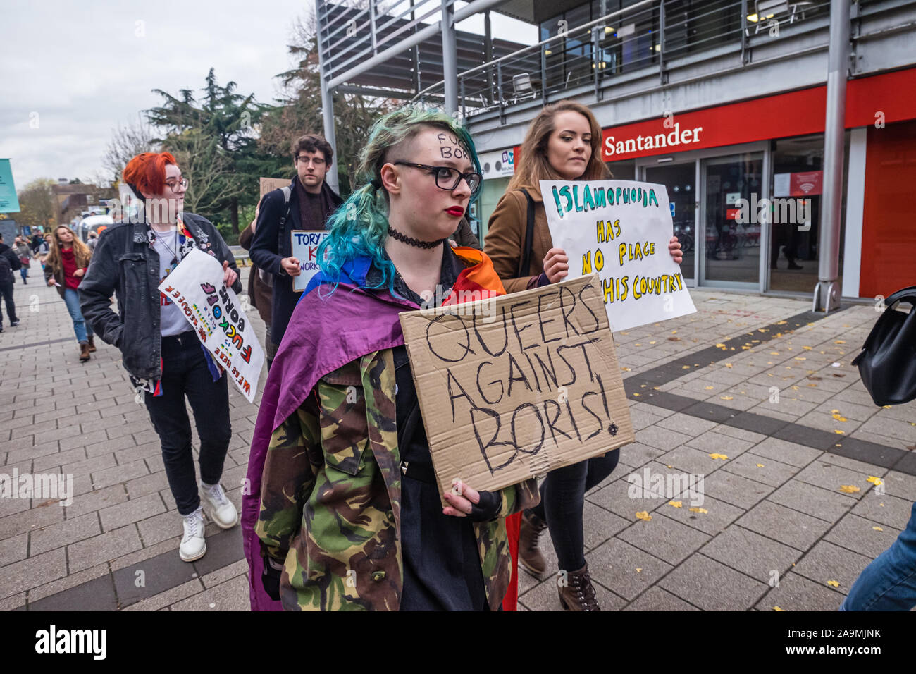 London, UK. 16th November 2019. A protest holds a poster 'Queers Against Boris!' as protesters from FCKBoris urge  everyone at Brunel University in Uxbridge to register and vote against Boris Johnson and kick him out for his racist, elitist politics.  Johnson had a majority of just over 5 thousand in 2017 and Labour candidate Ali Milani has strong hopes of beating him and the other 10 candidates. Peter Marshall/Alamy Live News Stock Photo