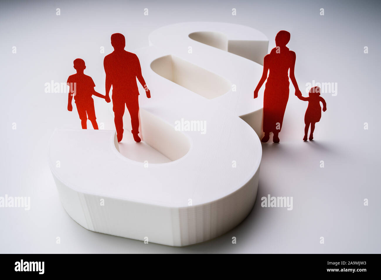 Close-up Of A Red Paper Cutout Of A Separated Family With White Paragraph Sign Stock Photo