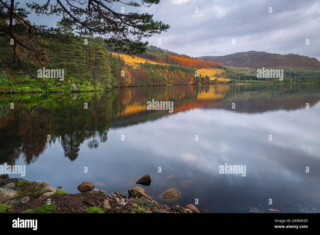 An autumnal HDR image of the reflective still waters of Loch Farr in Strathnairn, Scotland. 05 November 2019 Stock Photo