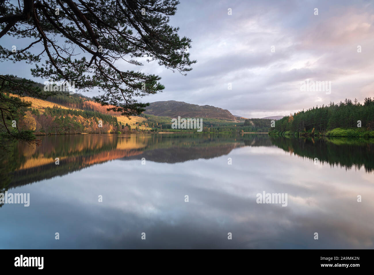 An autumnal HDR image of the reflective still waters of Loch Farr in Strathnairn, Scotland. 05 November 2019 Stock Photo