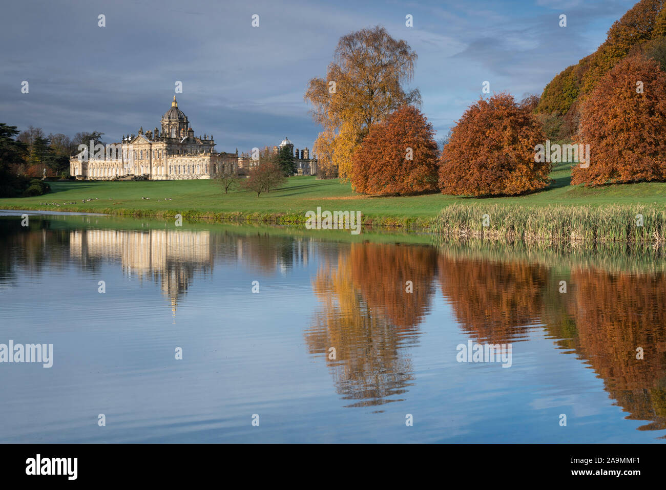 Autumn trees reflected in the lake at Castle Howard, UK. Stock Photo