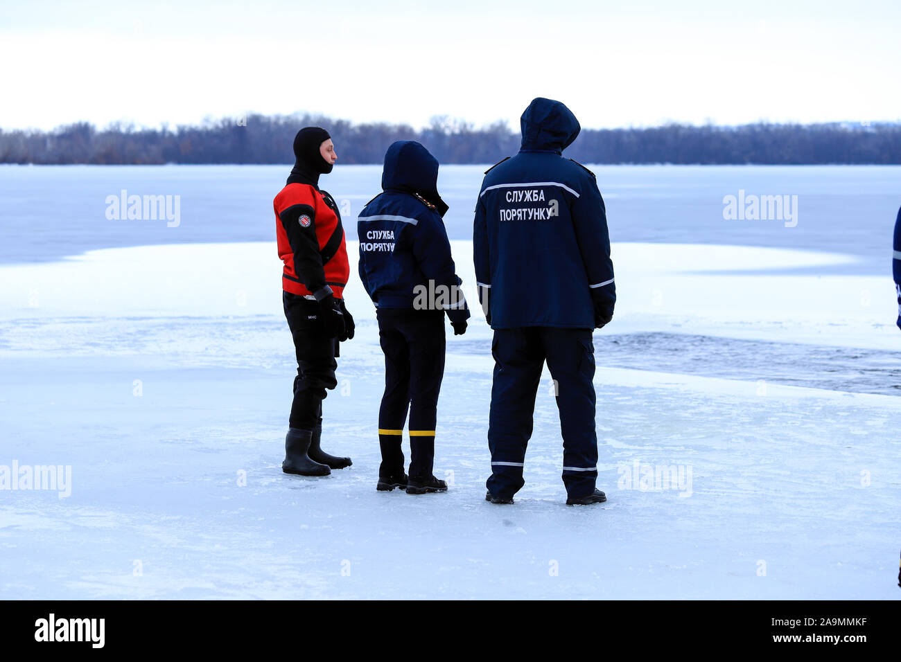 Dnipro city, Ukraine,19.01 2019.Rescuers in uniform and diving suit are on duty on the frozen river during winter fishing and sport events. Rescue Stock Photo