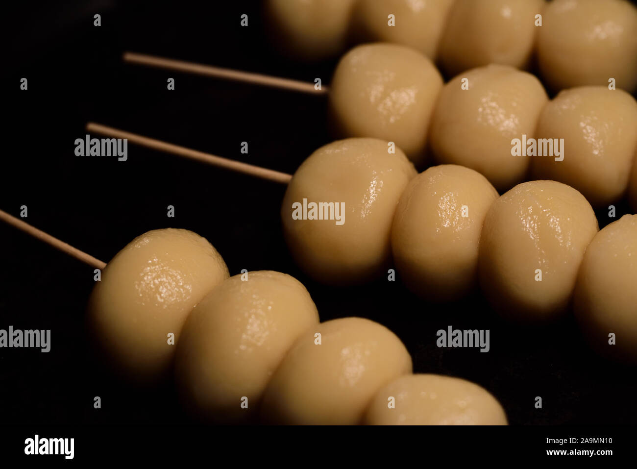 small round fresh japanese dango lying in a pan for a barbecue Stock Photo