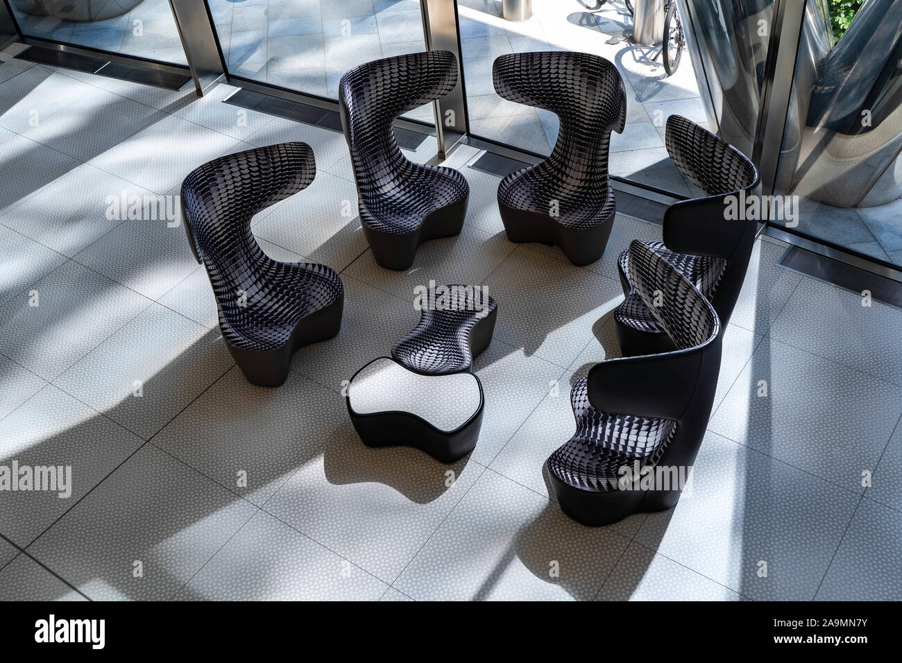 Warsaw, Poland - August 2019: View of the restaurant-bar zone inside the Warsaw Spire Building with armchairs and ottomans. Stock Photo