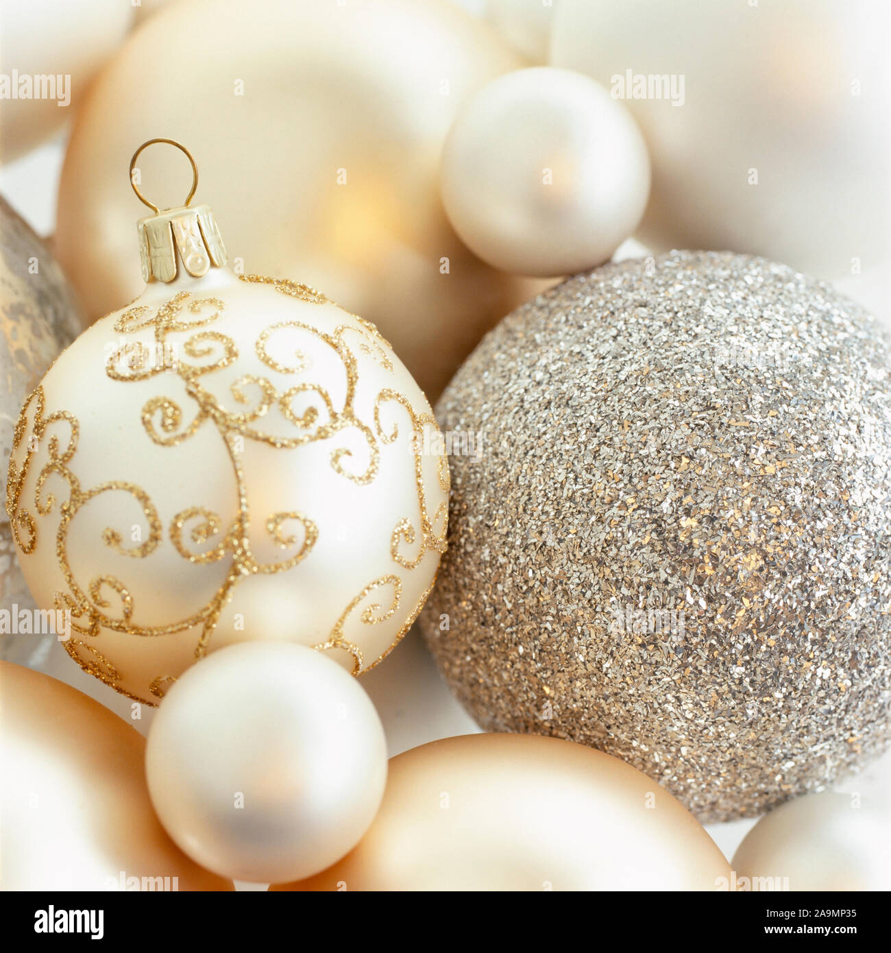 Close-up closeup of beautiful, fancy, elegant, silver, white and gold Christmas baubles ornaments. Luxury holiday decorations backgrounds. Selective f Stock Photo