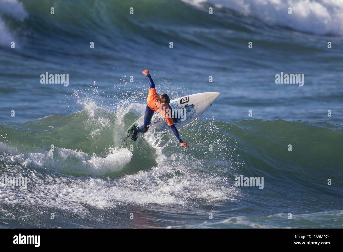 Surfer wearing Orange Shirt Cut Back Stock Photo
